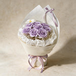 Always Yours soap flower bouquet of eight lilac roses and a cosmos in cream wrap