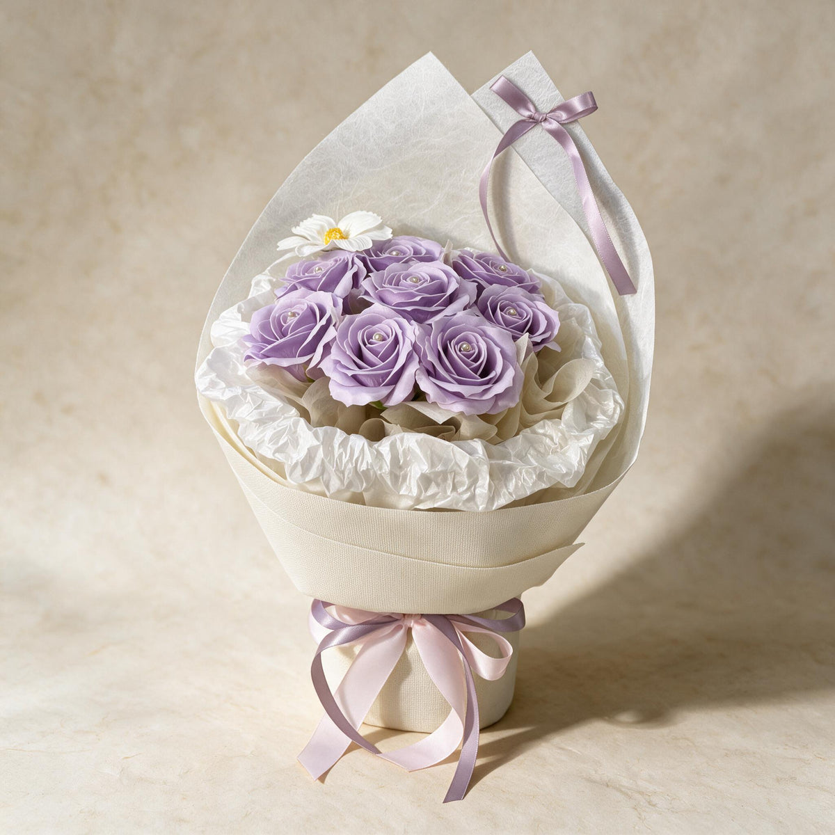 Always Yours soap flower bouquet of eight lilac roses and a cosmos in cream wrap