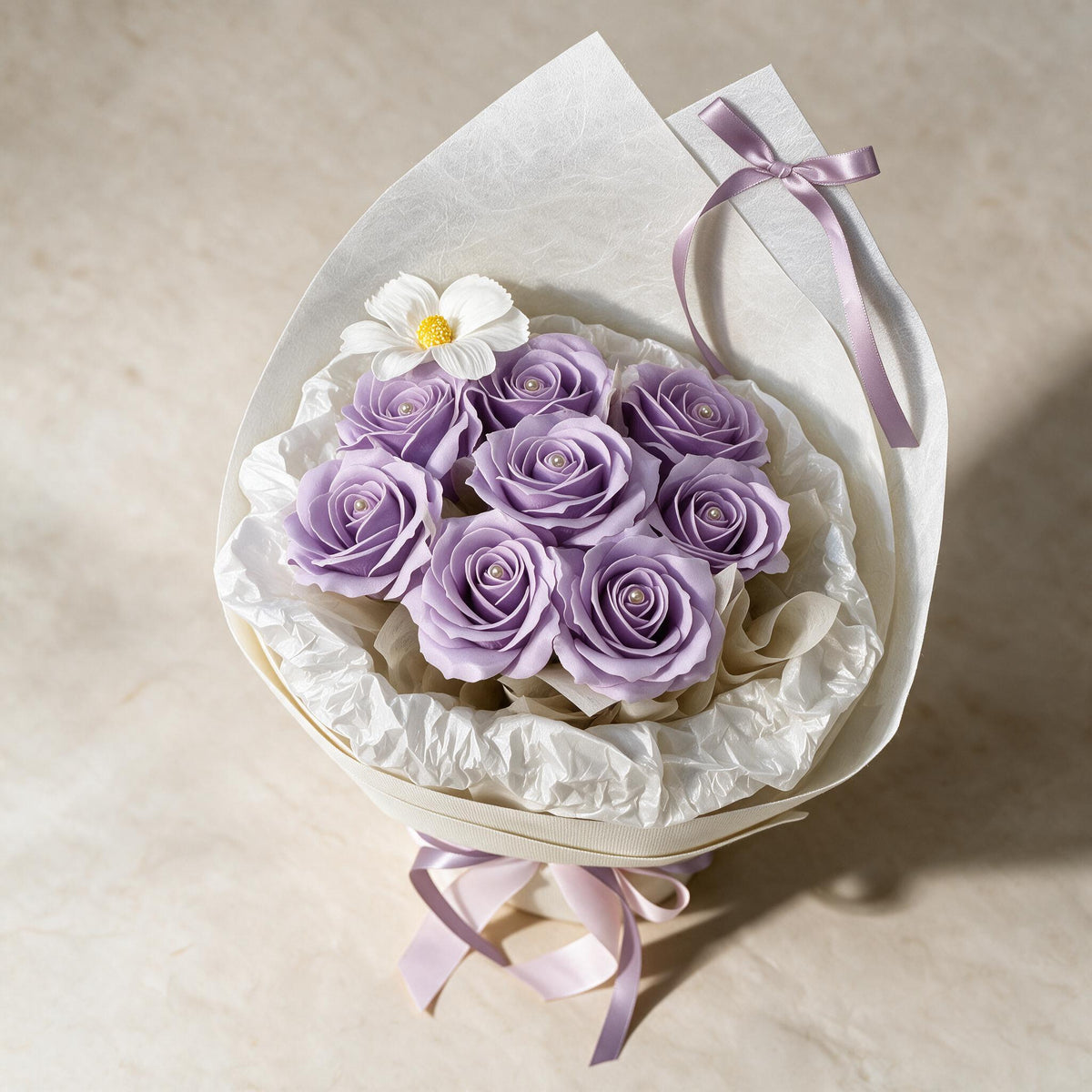 Top view of the Always Yours soap flower bouquet of eight lilac roses and a cosmos