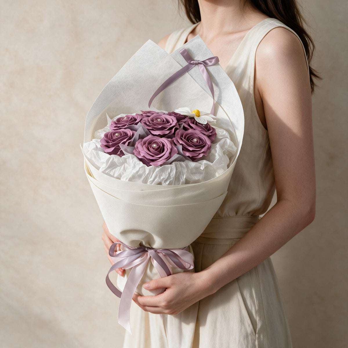 Woman holding the purple Always Yours soap flower bouquet in cream wrap