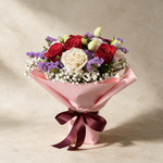 Beloved fresh flower bouquet of six red and cream roses with statice, eustoma and baby’s breath in pink wrap