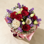 Top view of the Beloved fresh flower bouquet of six red and cream roses with statice, eustoma and baby’s breath