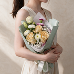 Woman holding the Darling fresh flower bouquet in sage green wrap
