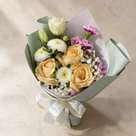 Top view of the Darling fresh flower bouquet of three peach roses with spray carnations, asters, eustoma and baby’s breath