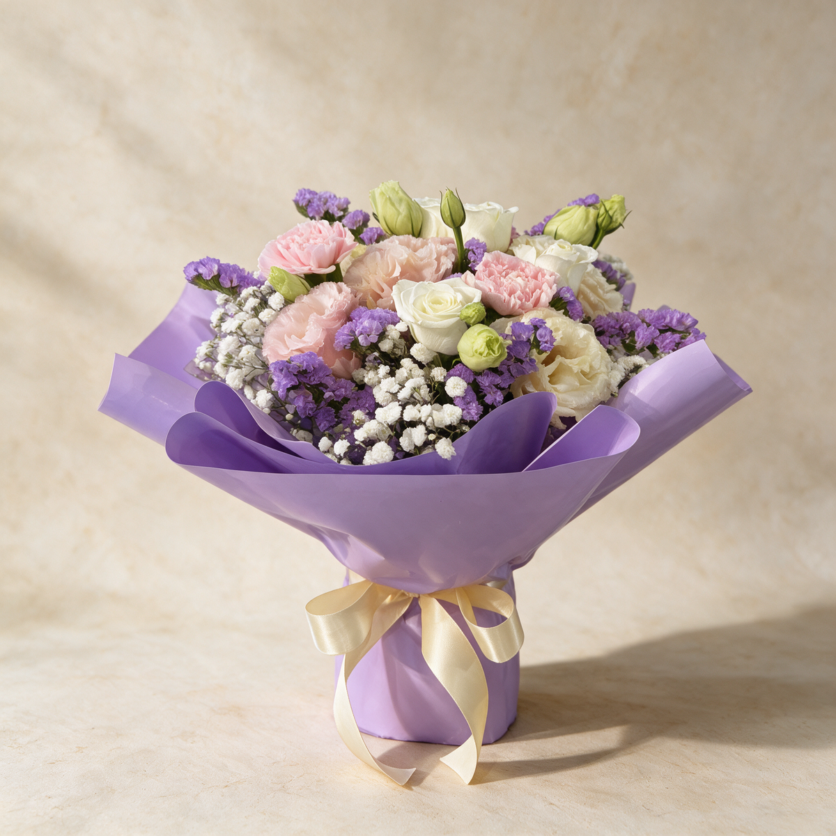 Daydream fresh flower bouquet of three pink roses with carnations, eustoma, statice and baby’s breath in lilac wrap