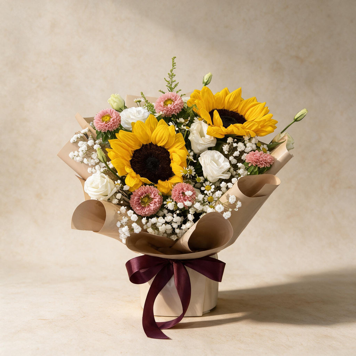 Dreamy Days fresh flower bouquet of two sunflowers with pink asters, eustoma and baby’s breath in kraft paper