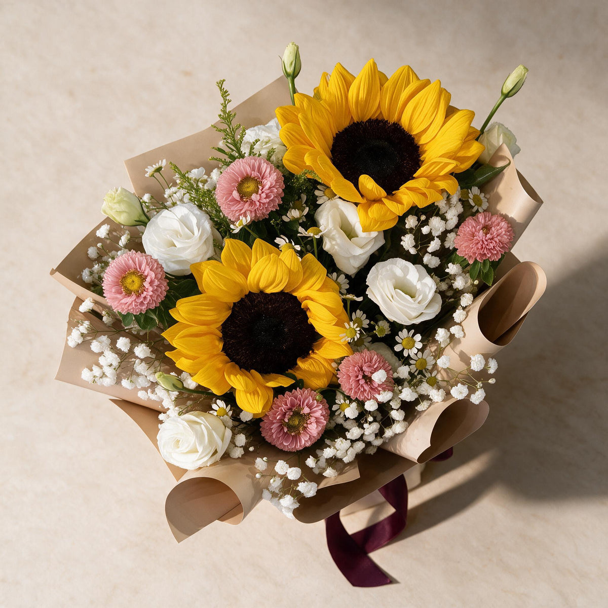 Top view of the Dreamy Days fresh flower bouquet of two sunflowers with pink asters, eustoma and baby’s breath