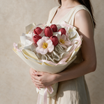 Woman holding the Forever Mine soap flower bouquet in white ruffled wrap