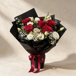 Gentle Kiss fresh flower bouquet of six red roses with eustoma, baby’s breath and eucalyptus in black wrap
