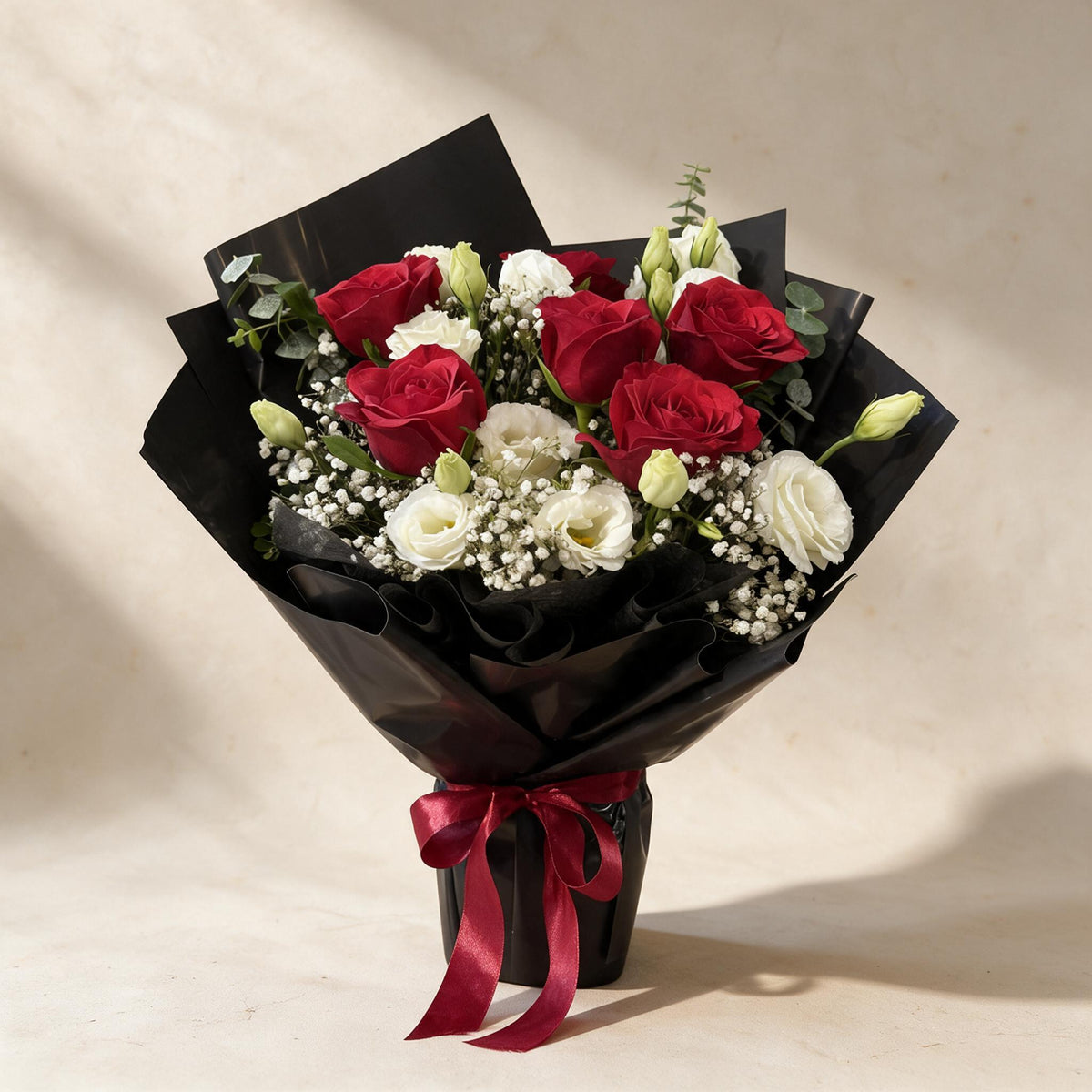 Gentle Kiss fresh flower bouquet of six red roses with eustoma, baby’s breath and eucalyptus in black wrap