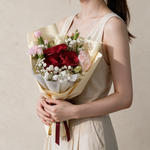 Woman holding the Keepsake fresh flower bouquet in cream wrap