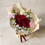Top view of the Keepsake fresh flower bouquet of three red roses with spray carnations, eustoma and baby’s breath