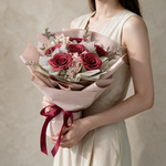Woman holding the Love Spell soap flower bouquet in blush pink wrap