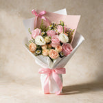 Pure Bliss fresh flower bouquet of five pink roses with spray roses, eustoma and white and yellow peacock in pink and white wrap