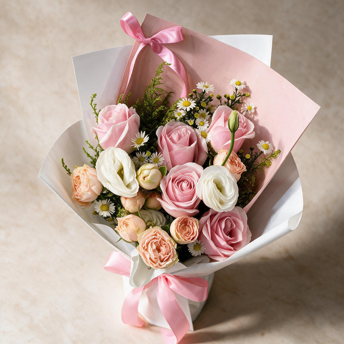Top view of the Pure Bliss fresh flower bouquet of five pink roses with spray roses, eustoma and white and yellow peacock