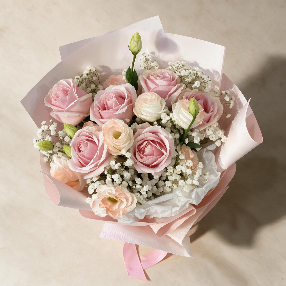 Top view of the Secret Crush fresh flower bouquet of six pink roses with eustoma and baby’s breath
