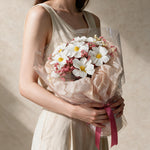 Woman holding the Sweet Promise soap flower bouquet in sheer blush wrap