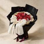 True Affection soap flower bouquet of eight red roses and a cosmos in black and gold wrap
