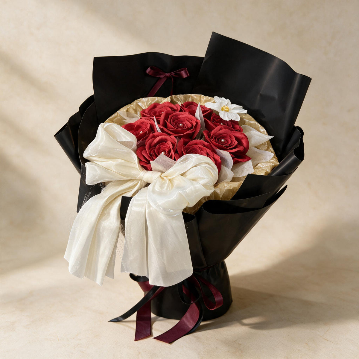 True Affection soap flower bouquet of eight red roses and a cosmos in black and gold wrap