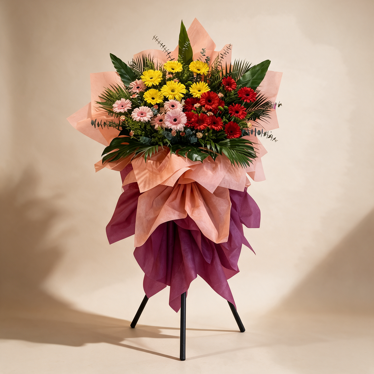 Abundance grand opening flower stand of yellow, pink and red gerbera daisies with spray carnations