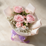 Top view of the Blush fresh flower bouquet of three pink roses with spray carnations