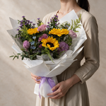 Woman holding the Bright Future fresh flower bouquet of sunflowers