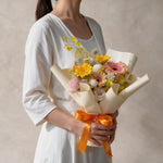 Woman holding the Charming fresh flower bouquet of gerbera daisies