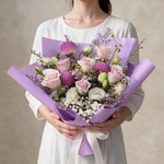 Woman holding the Enchanted fresh flower bouquet of pink roses