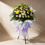 Eternal Peace condolence flower stand of white daisies, yellow chrysanthemums and purple peacock flowers