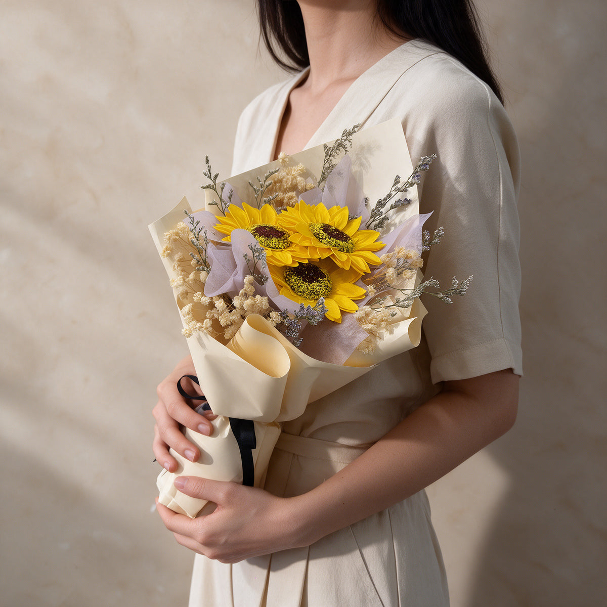 Woman holding the Glow soap flower bouquet of sunflowers
