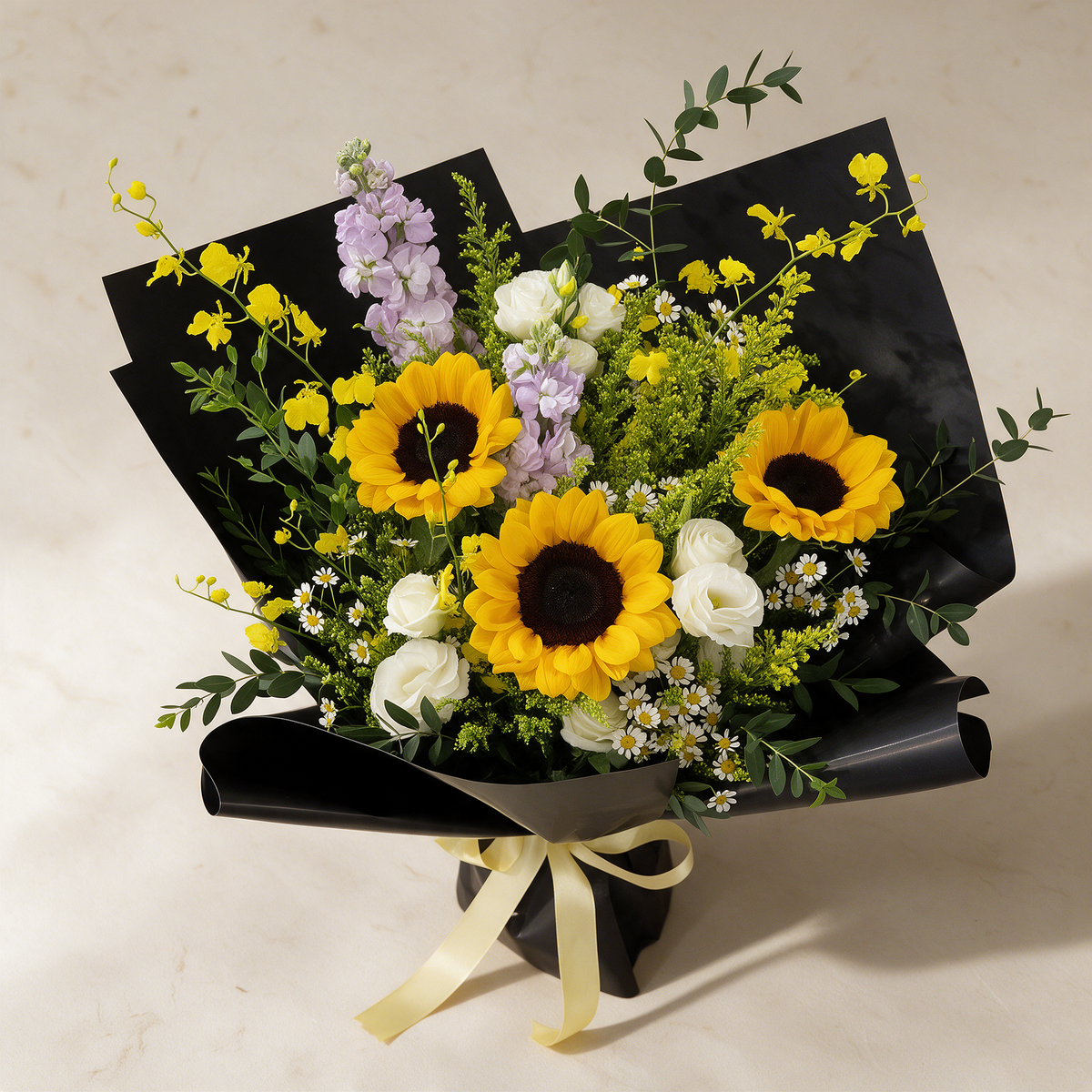 Top view of the Golden Hour fresh flower bouquet of three sunflowers with dancing lady orchids