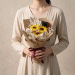 Woman holding the Hats Off soap flower graduation bouquet