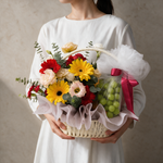 Woman holding the Hopeful fresh flower and fruit basket