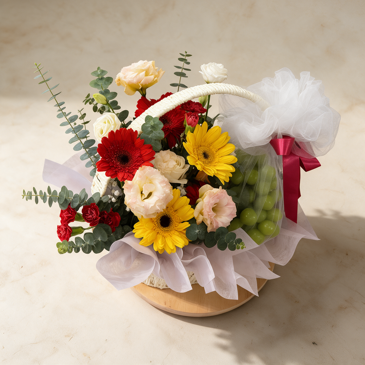 Top view of the Hopeful fresh flower and fruit basket of gerbera daisies with green grapes