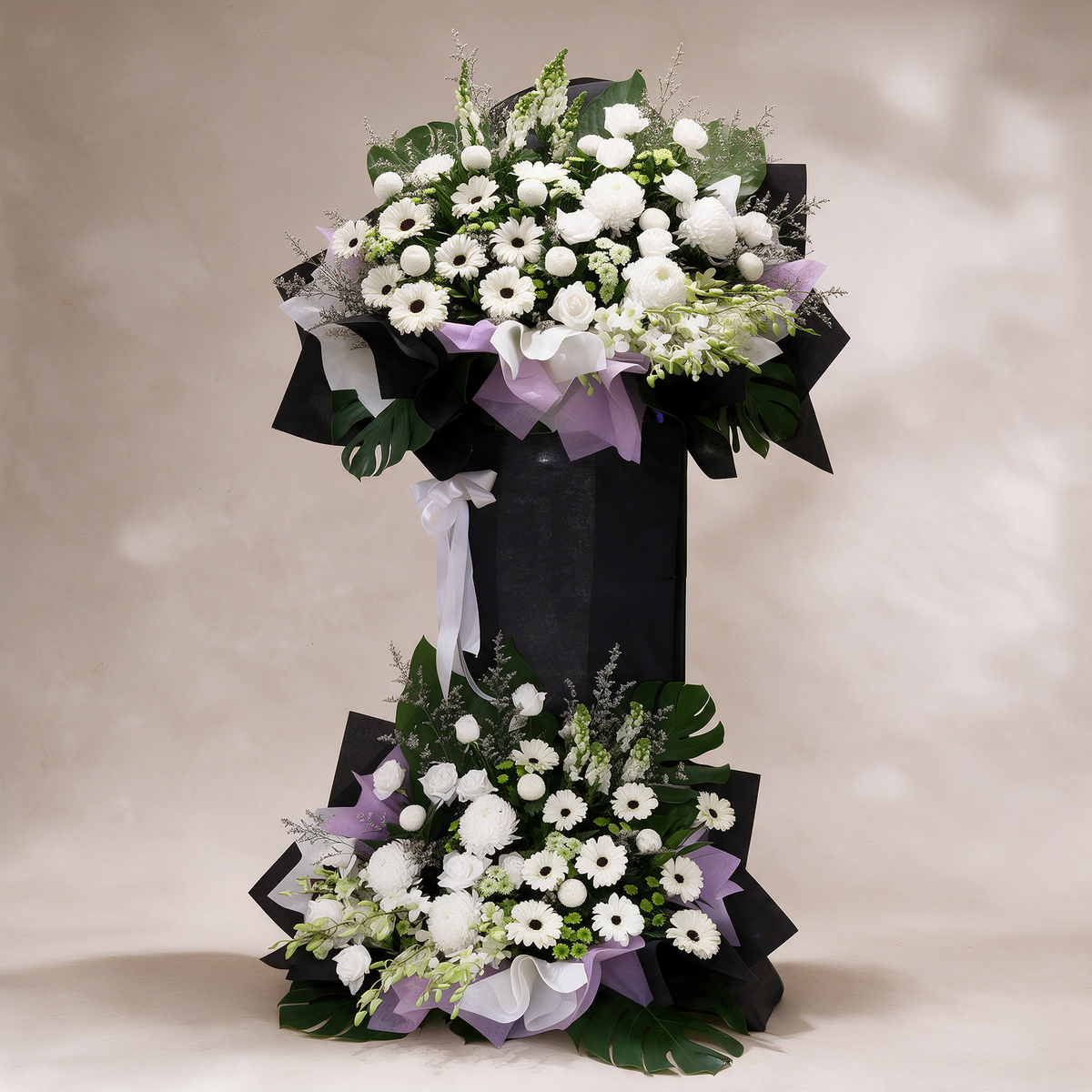 Legacy all-white two-tier condolence flower stand of daisies, chrysanthemums, roses and dendrobium orchids
