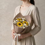 Woman holding the Little Sunshine soap flower graduation bouquet