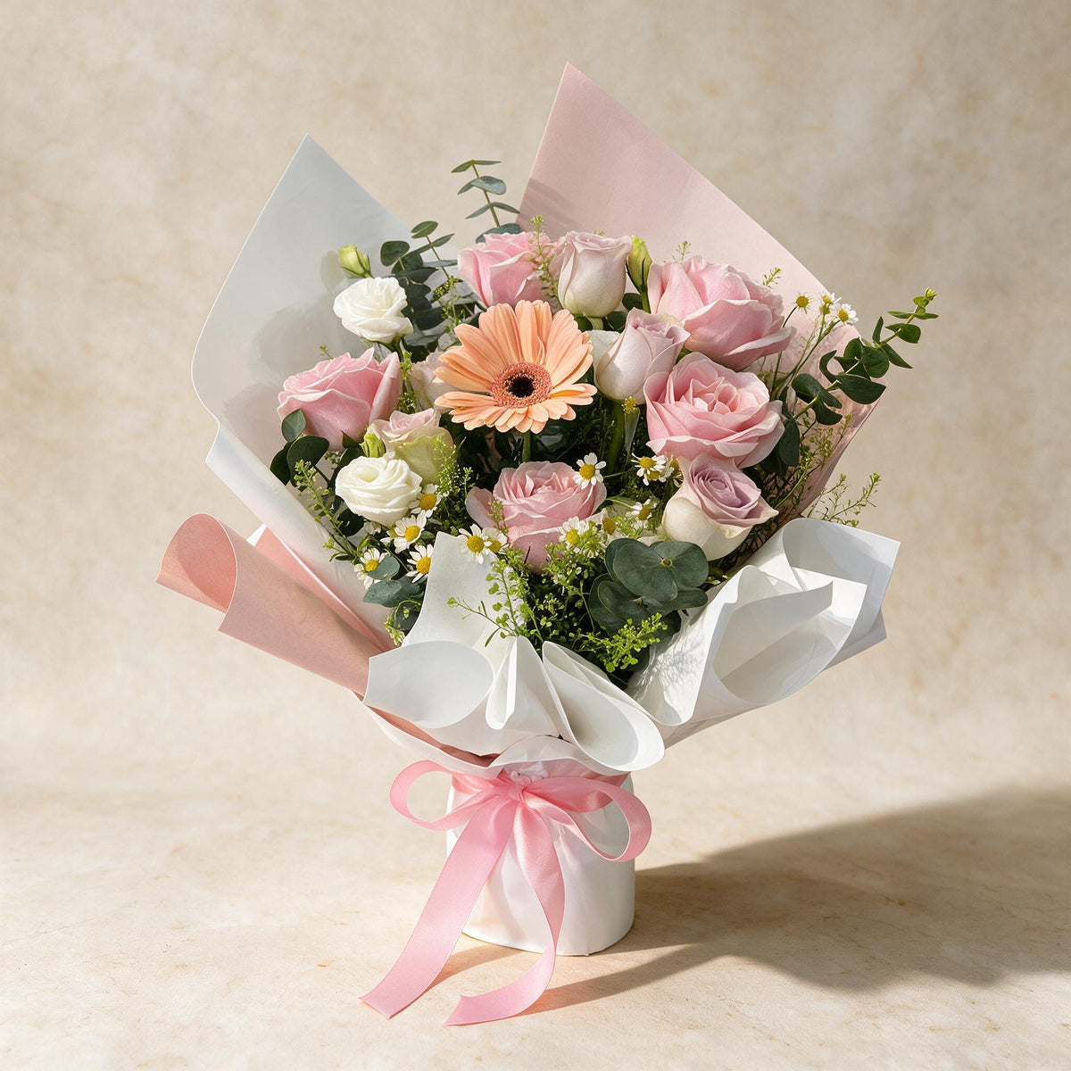 Love Story fresh flower bouquet of ten pink roses and a peach daisy with mini daisies, eustoma, eucalyptus and thlaspi green bells in white and pink wrap