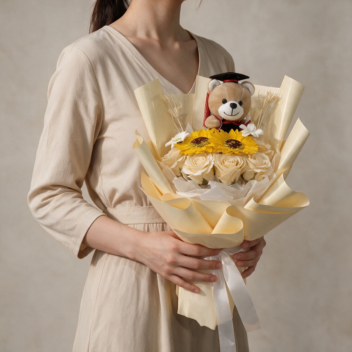 Woman holding the Milestone soap flower graduation bouquet