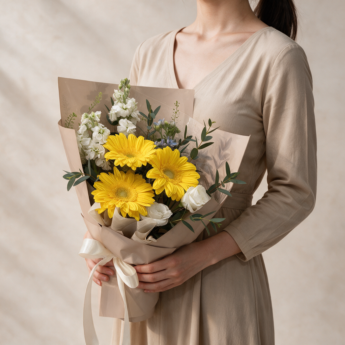 Woman holding the Next Chapter fresh flower graduation bouquet