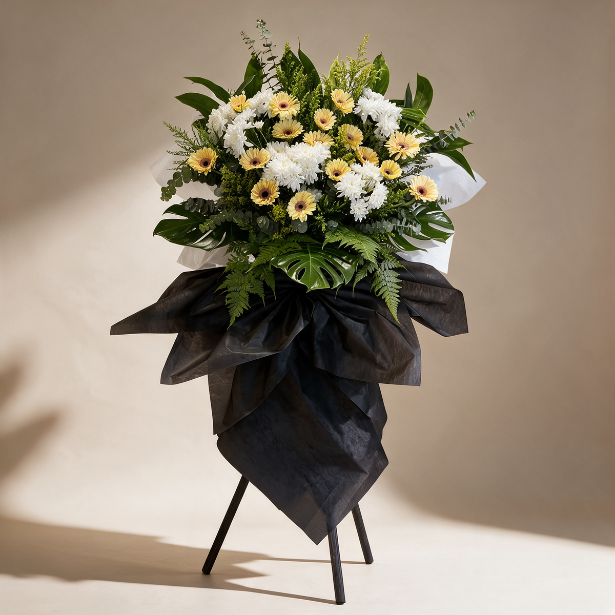 Remembrance condolence flower stand of cream daisies and white pom chrysanthemums