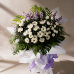 Close-up of the Reverence condolence flower stand of white daisies, eustoma and lilac matthiola