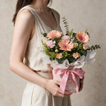 Woman holding the Serendipity fresh flower bouquet