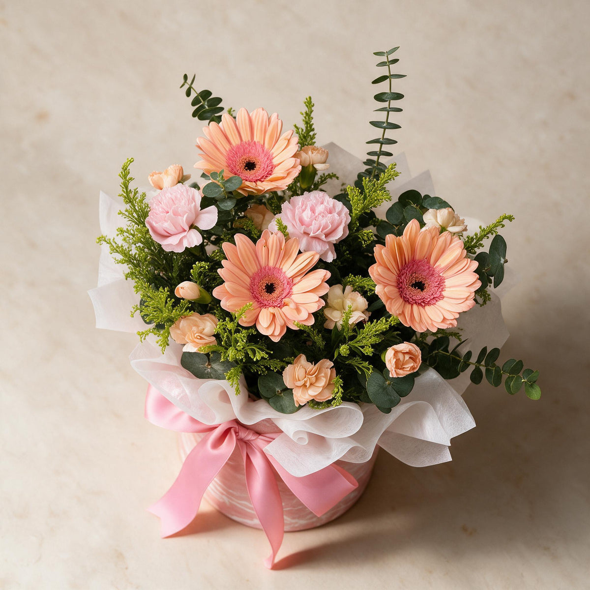 Top view of the Serendipity fresh flower bouquet of three peach daisies with spray carnations, yellow peacock and eucalyptus