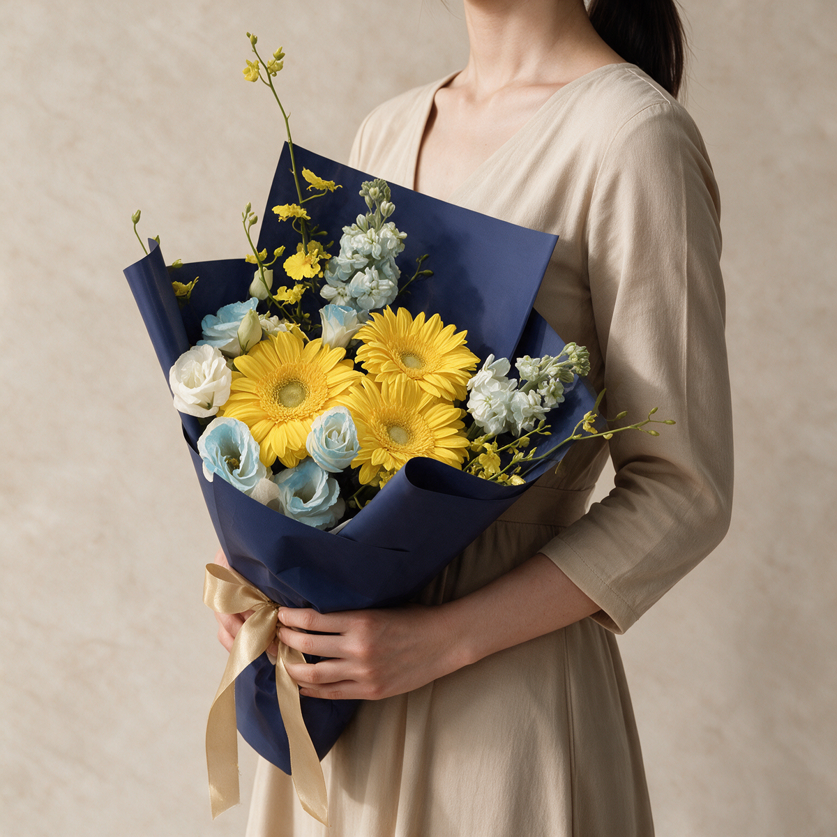 Woman holding the Soar fresh flower graduation bouquet