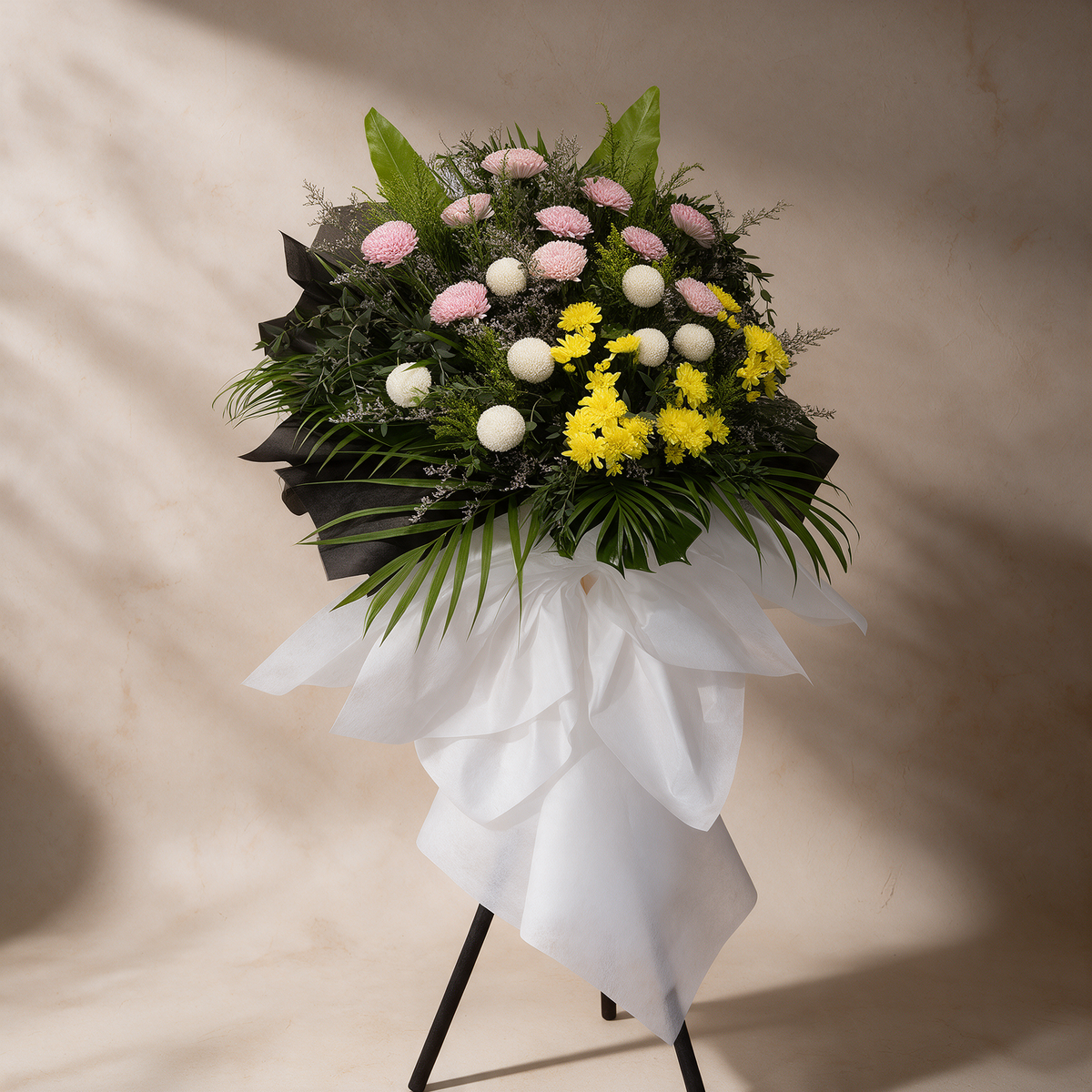 Side view of the Solace funeral flower stand of chrysanthemums