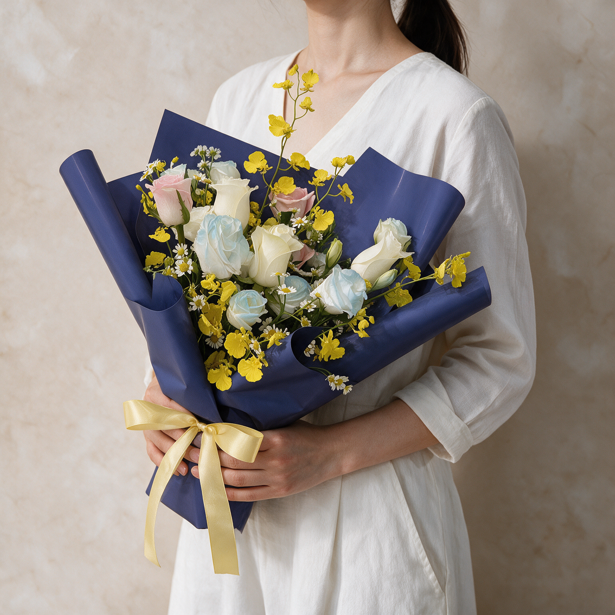 Woman holding the Starlight fresh flower bouquet of white roses