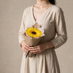 Woman holding the Sunbeam soap sunflower graduation bouquet