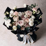 Top view of the Sweet Embrace fresh flower bouquet of six dusty pink roses with carnations, eustoma, scabiosa and eucalyptus