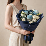 Woman holding the Tender Love fresh flower bouquet in navy wrap