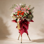Thrive grand opening flower stand of pink and orange gerbera daisies, matthiola and yellow statice